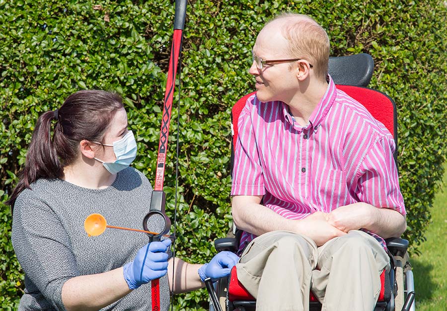 Hollybank resident and carer with bow and arrow