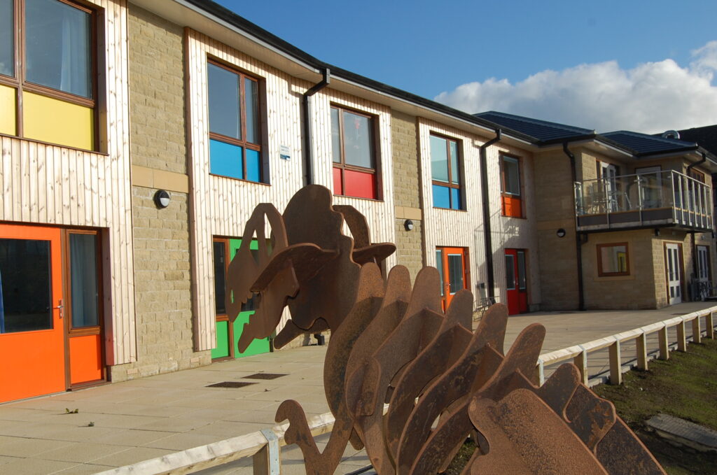 Hollybank rooms behind dinosaur sculpture