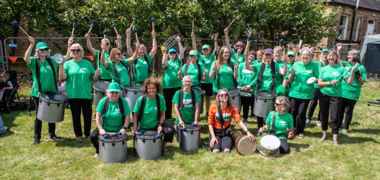 People playing instruments, smiling
